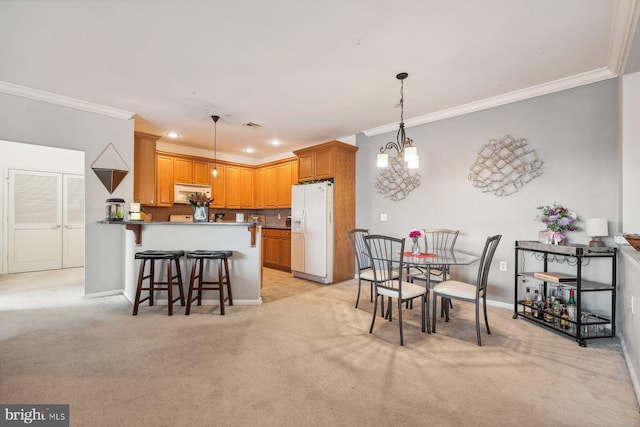 dining room with recessed lighting, light colored carpet, baseboards, and ornamental molding