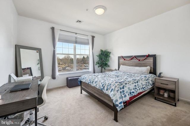 bedroom with light colored carpet, visible vents, and baseboards