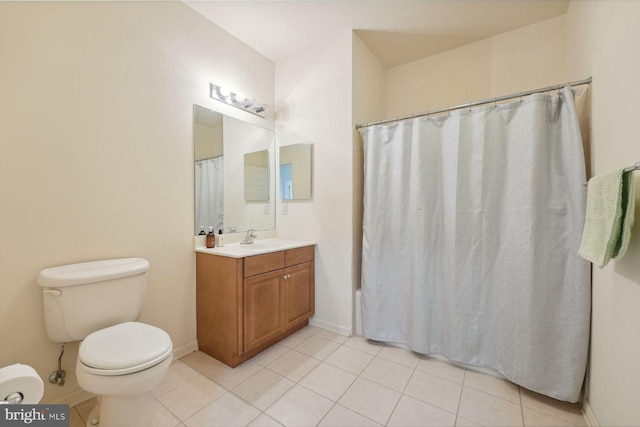 bathroom with tile patterned floors, toilet, vanity, and baseboards