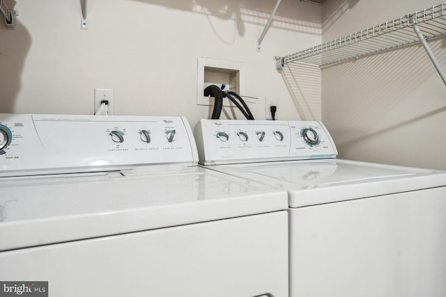 clothes washing area with washer and dryer and laundry area