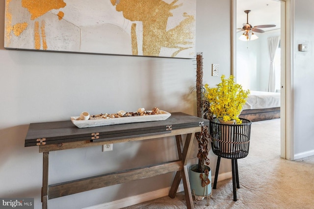 room details with carpet flooring, baseboards, and a ceiling fan