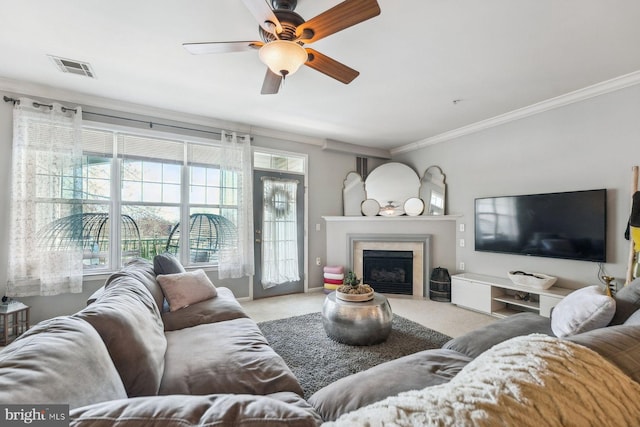 living room with crown molding, visible vents, carpet floors, and ceiling fan