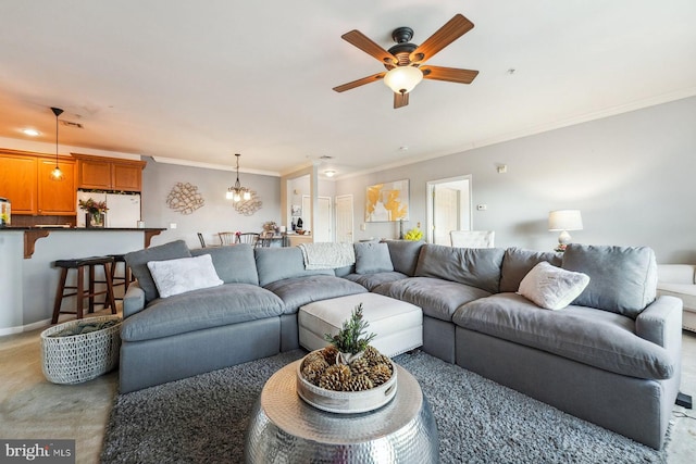 carpeted living area featuring ceiling fan with notable chandelier, crown molding, and baseboards