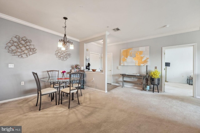 dining area featuring baseboards, visible vents, carpet floors, and ornamental molding