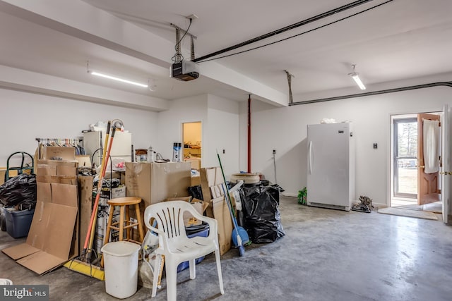 garage featuring a garage door opener and freestanding refrigerator