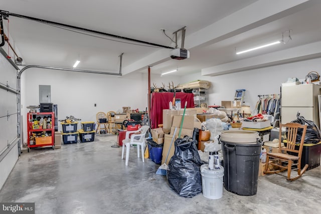 garage with a garage door opener and freestanding refrigerator