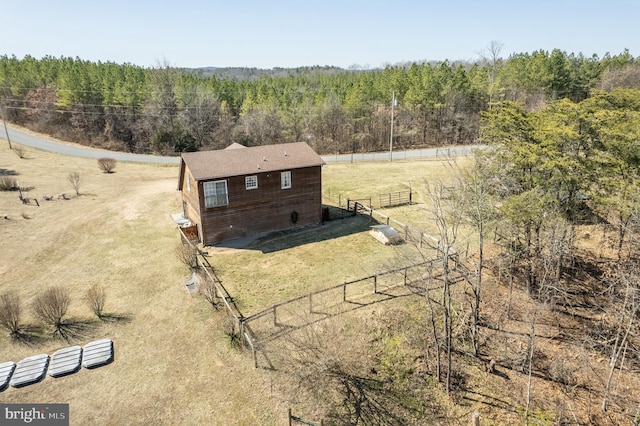 bird's eye view with a wooded view