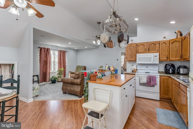 kitchen featuring backsplash, ceiling fan, light wood-type flooring, lofted ceiling, and white appliances