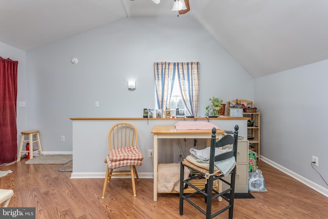 home office with lofted ceiling, wood finished floors, baseboards, and ceiling fan