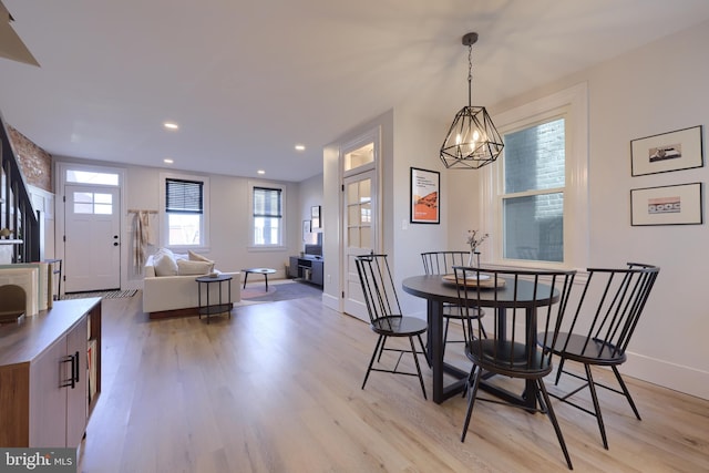 dining area with light wood-type flooring, baseboards, a chandelier, and recessed lighting