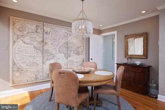 dining area with recessed lighting, crown molding, and wood finished floors