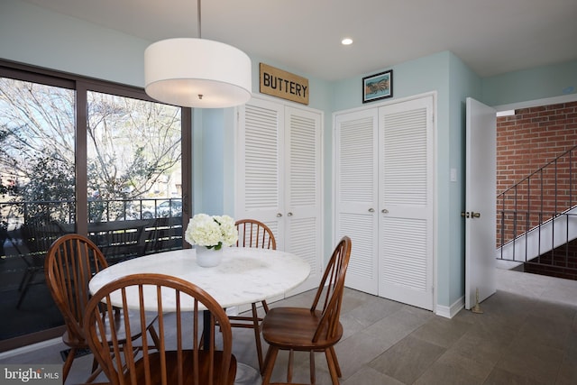 dining space with recessed lighting, baseboards, and stairs