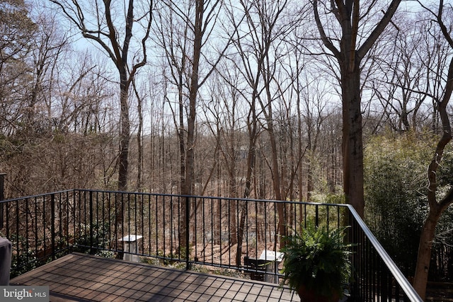 balcony featuring a view of trees