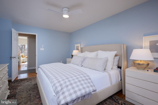 bedroom featuring a ceiling fan, dark wood-style flooring, and baseboards