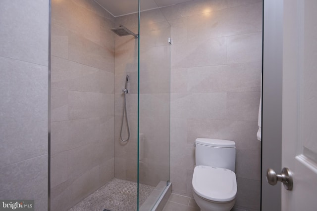 full bathroom with toilet and a tile shower