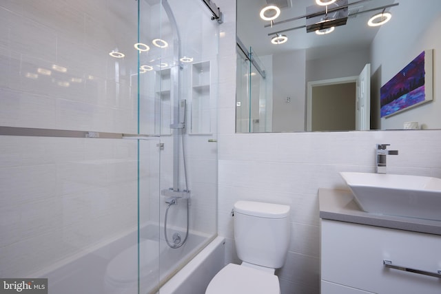 full bathroom with vanity, shower / washtub combination, tile walls, toilet, and tasteful backsplash