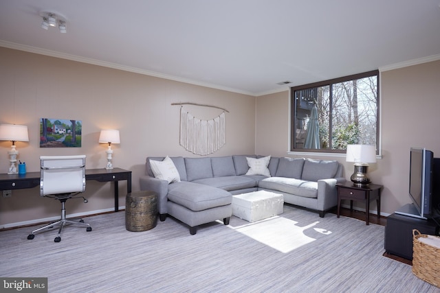 living area featuring visible vents, baseboards, and ornamental molding