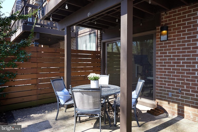 view of patio / terrace featuring outdoor dining area and fence