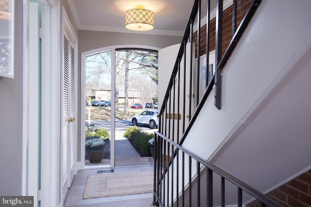 entryway featuring stairway and ornamental molding