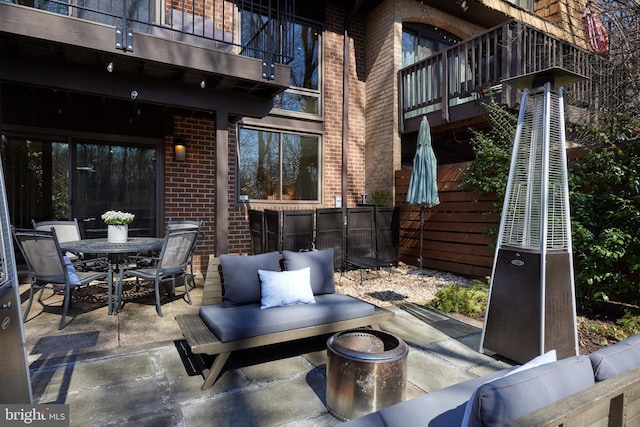 view of patio / terrace featuring a balcony and outdoor dining area