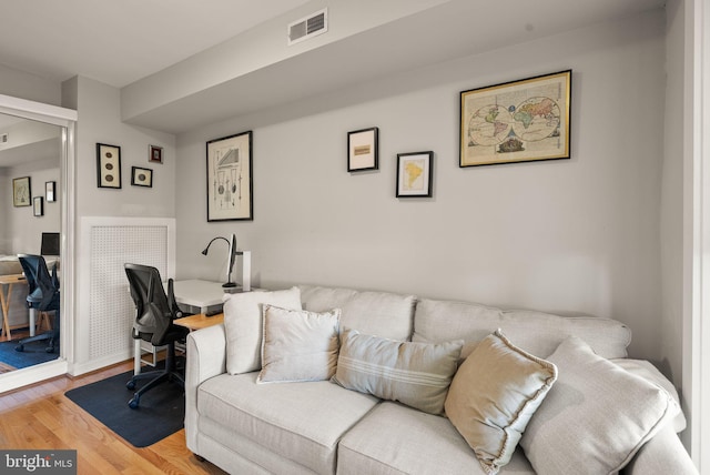 living room featuring visible vents and light wood-style floors