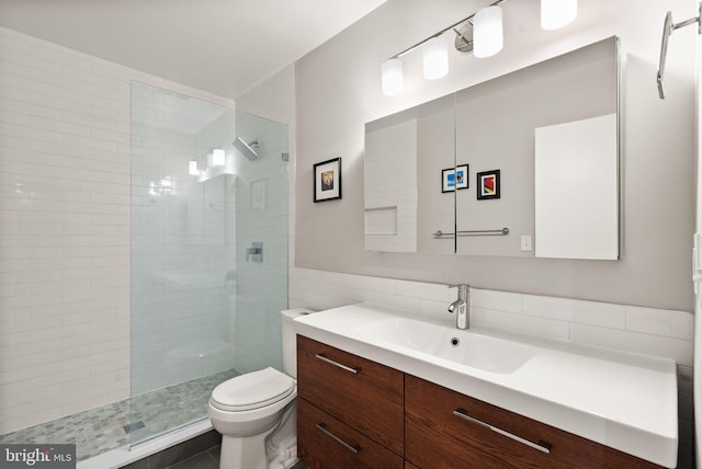 full bath featuring a walk in shower, vanity, toilet, and tile patterned floors