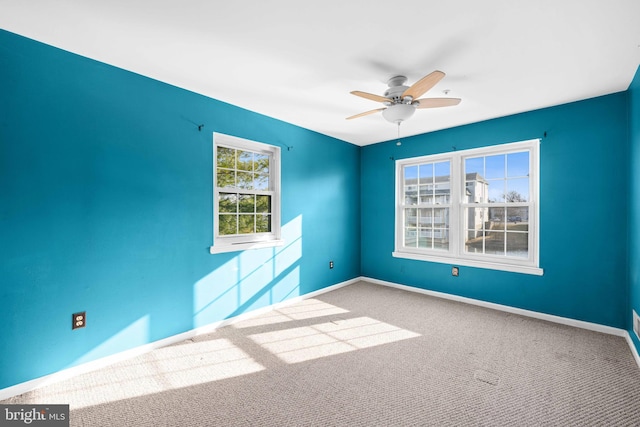 unfurnished room with carpet, baseboards, and ceiling fan