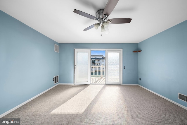 carpeted empty room with baseboards and visible vents