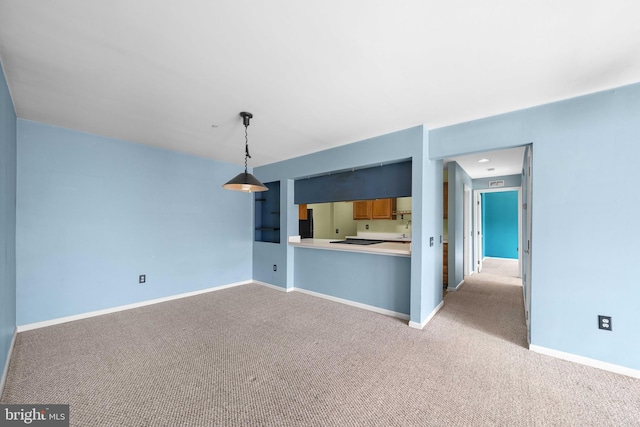 unfurnished living room featuring carpet and baseboards