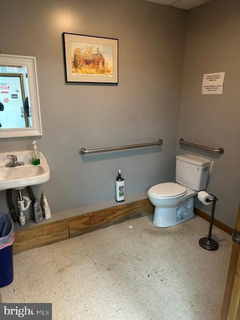 bathroom with tile patterned floors, toilet, and baseboards