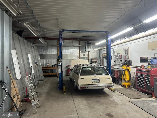 garage featuring a workshop area and metal wall