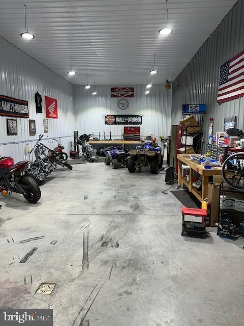 garage with a workshop area and metal wall