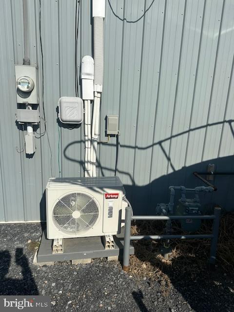 exterior details featuring ac unit and electric meter