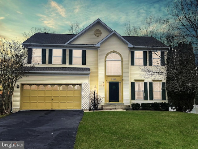 view of front facade with an attached garage, a shingled roof, driveway, and a front yard