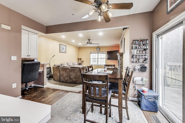 dining area featuring wood finished floors, a ceiling fan, visible vents, baseboards, and recessed lighting