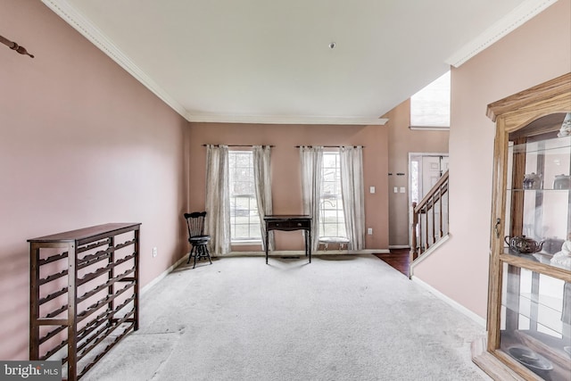 foyer entrance with carpet flooring, stairway, crown molding, and baseboards