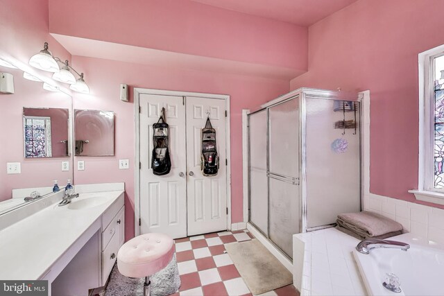 full bathroom featuring tile patterned floors, a garden tub, a stall shower, and vanity
