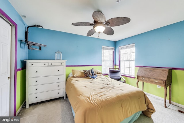 carpeted bedroom with baseboards and ceiling fan
