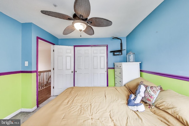 bedroom featuring a closet, baseboards, and ceiling fan