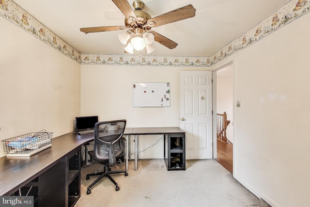 office space featuring light carpet, baseboards, and ceiling fan