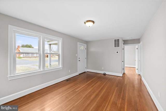 interior space featuring visible vents, baseboards, and wood finished floors