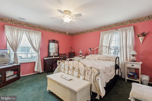 bedroom featuring dark colored carpet, visible vents, and a ceiling fan