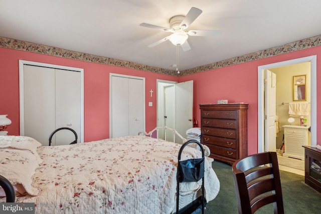 bedroom featuring ensuite bath, ceiling fan, dark colored carpet, and two closets