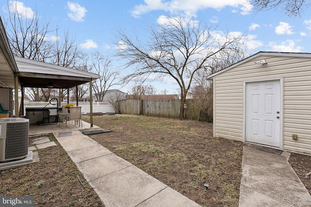 view of yard with central air condition unit, a fenced backyard, a patio, and an outdoor structure