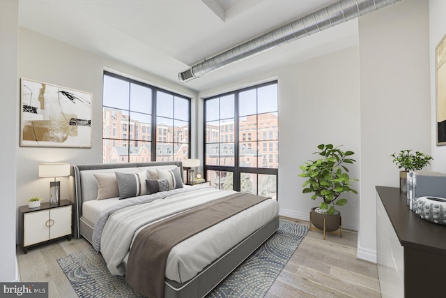 bedroom featuring baseboards and light wood-style floors