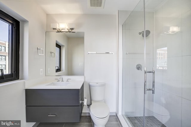 bathroom featuring a stall shower, visible vents, vanity, and toilet