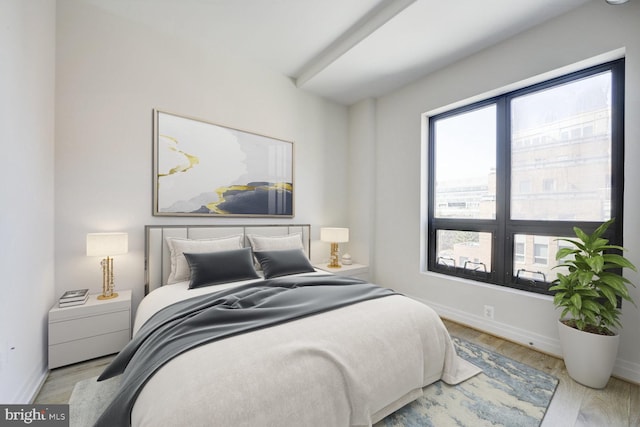 bedroom with baseboards and wood finished floors