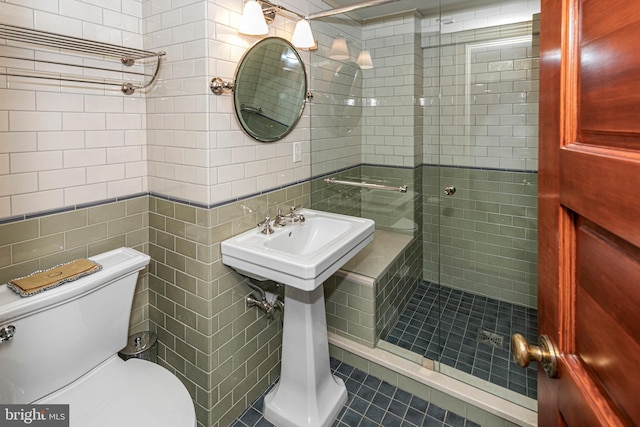 82 Library Pl, Princeton, NJ 08540 - bathroom with tile walls, a stall shower, toilet, and tile patterned flooring