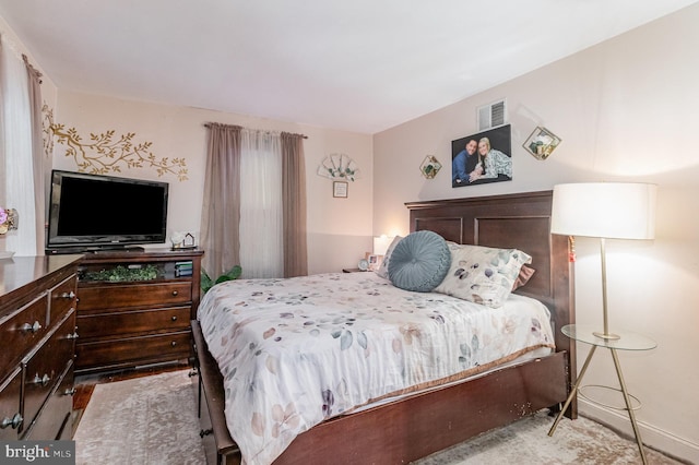 bedroom with baseboards and visible vents