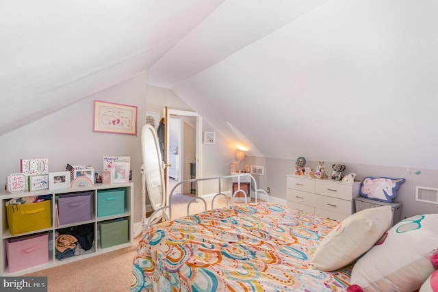 carpeted bedroom with visible vents and vaulted ceiling